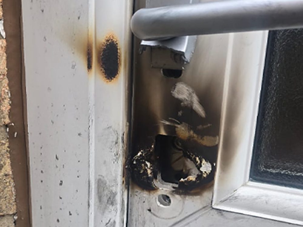 A LocksmithLocal locksmith repairing a forced door lock
