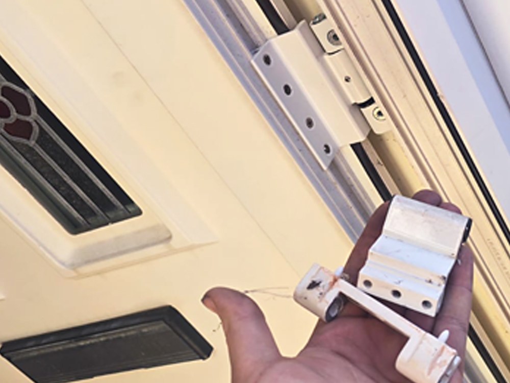 A worn composite door hinge replaced to realign the door