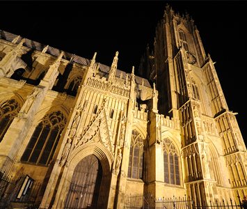 Beverley Minster floodlit at night, the Grade I listed Gothic church of St John and St Martin — one of the largest parish churches in the country, larger than many English cathedrals, with its famous Perpendicular twin west towers