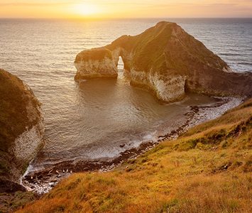 The "Drinking Dinosaur" sea arch at Flamborough Head, one of the chalk stacks and natural arches carved into the headland's cliffs