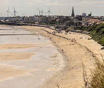 The view from the cliffs at Sewerby looking south along Bridlington's North Beach, with the town and Flamborough's chalk headland beyond