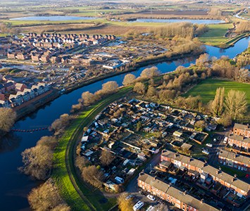 An aerial view over Castleford, where the River Aire winds past rows of houses close to its confluence with the River Calder
