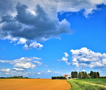 Rolling farmland and a distant farmhouse in the countryside around Doncaster