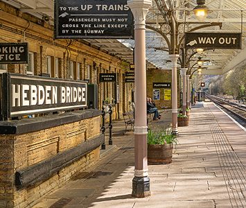 The traditional platform and station sign at Hebden Bridge railway station, a well-preserved Victorian stop on the Calder Valley line