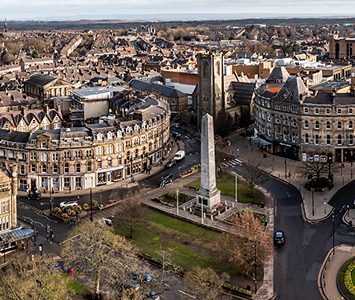 An aerial view over central Harrogate, the war memorial cenotaph standing on its island among the town's handsome stone buildings