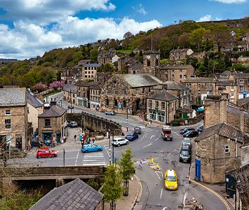 The centre of Holmfirth, the Holme Valley town clustered around its bridge and old stone buildings, with the hills rising behind
