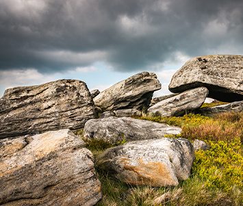Gritstone boulders on the open moorland above Meltham, looking out over the Pennine uplands south of Huddersfield