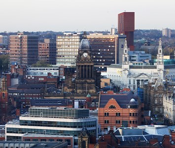 The Leeds city centre skyline, with the landmark clock tower of Leeds Town Hall rising above the rooftops