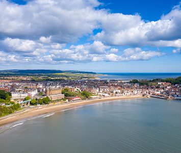 An aerial view over Scarborough's South Bay, the sweep of sands and the seafront town — a short drive from here