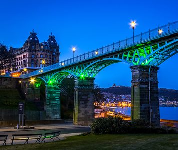 The Victorian Cliff Bridge (the old Spa Bridge) lit at dusk, with the Grand Hotel above it in nearby Scarborough