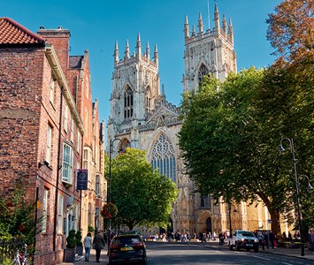 York Minster, the great medieval Gothic cathedral with its twin west towers, viewed from a street in the city centre